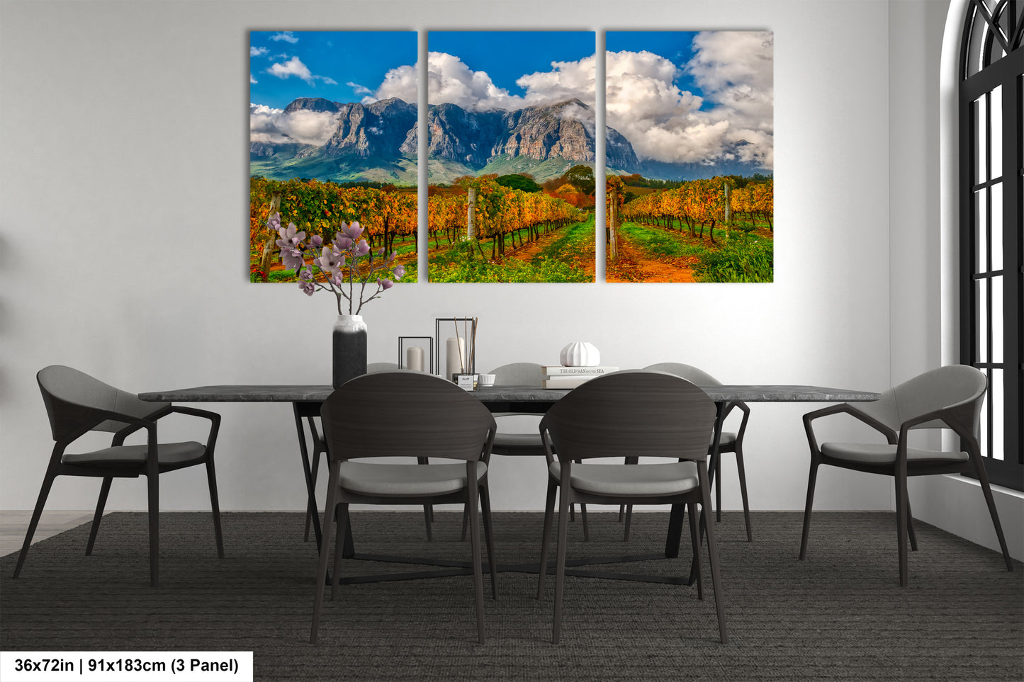 a dining room table with chairs and a painting on the wall