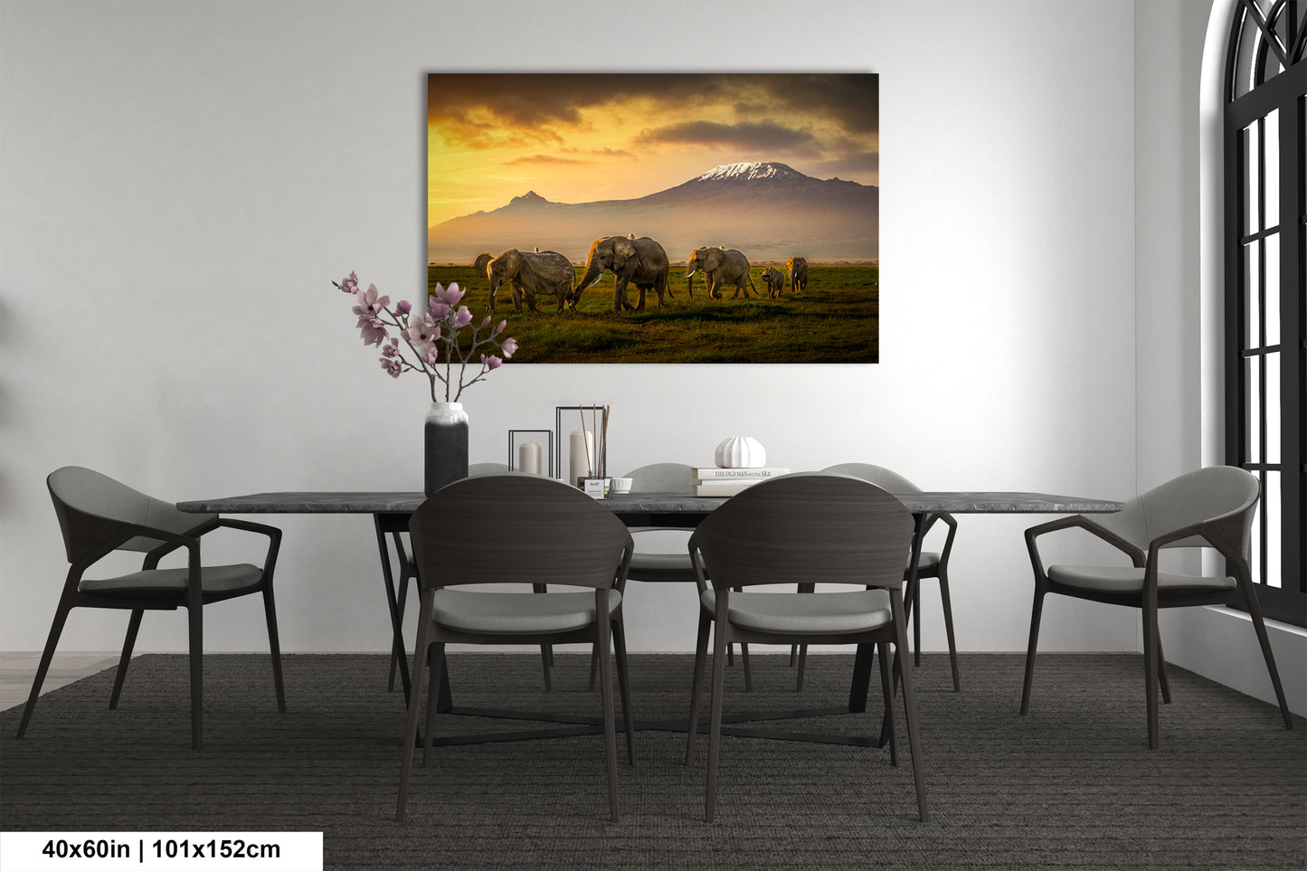 a dining room table with chairs and a painting on the wall