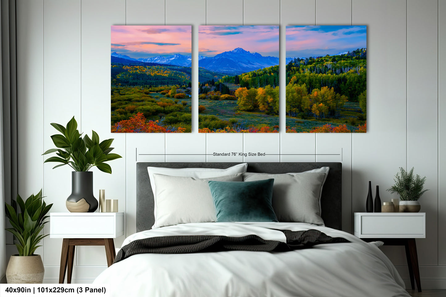 a bedroom with a bed and two paintings on the wall