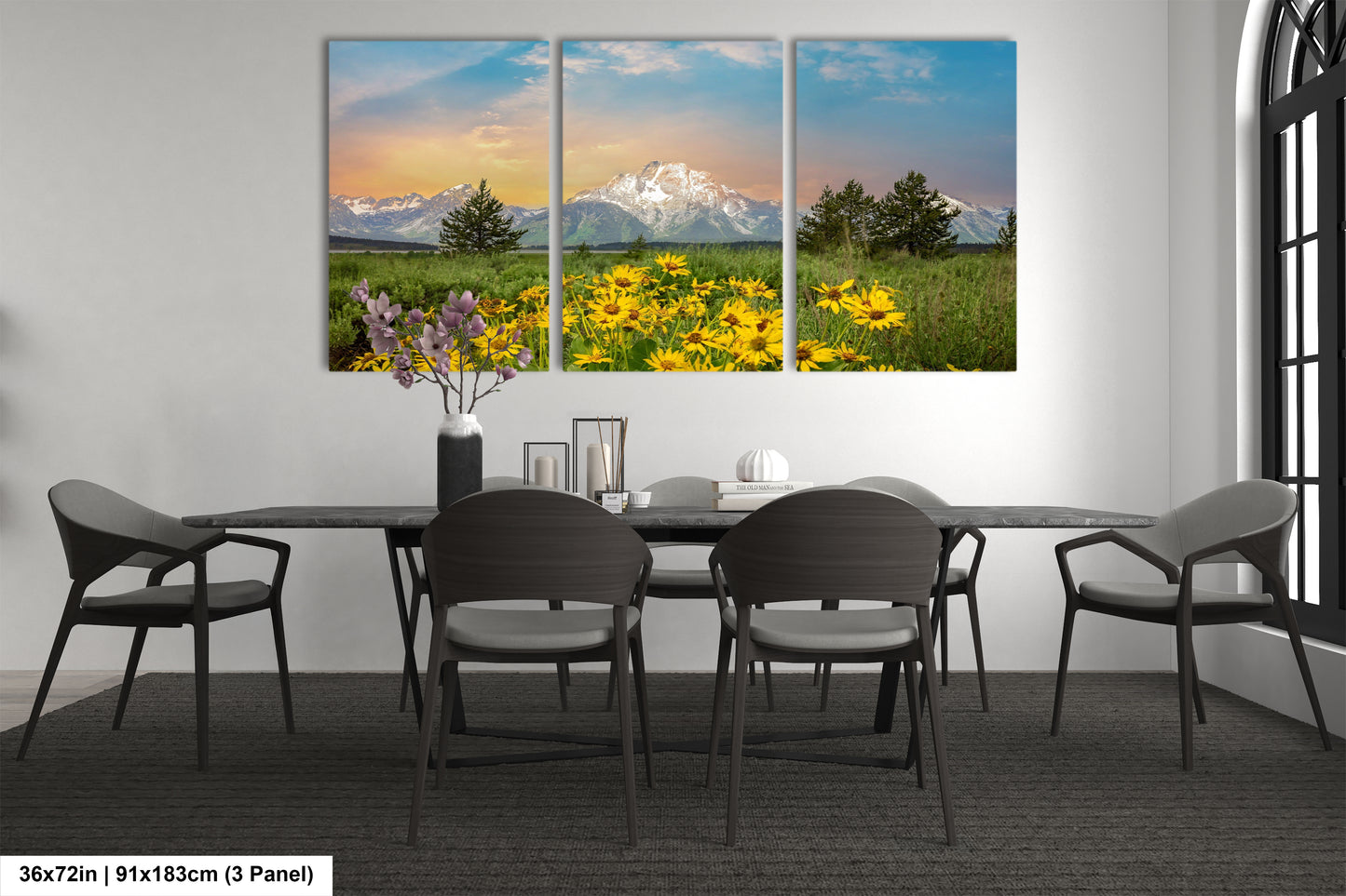 a dining room table with four chairs and a vase of flowers