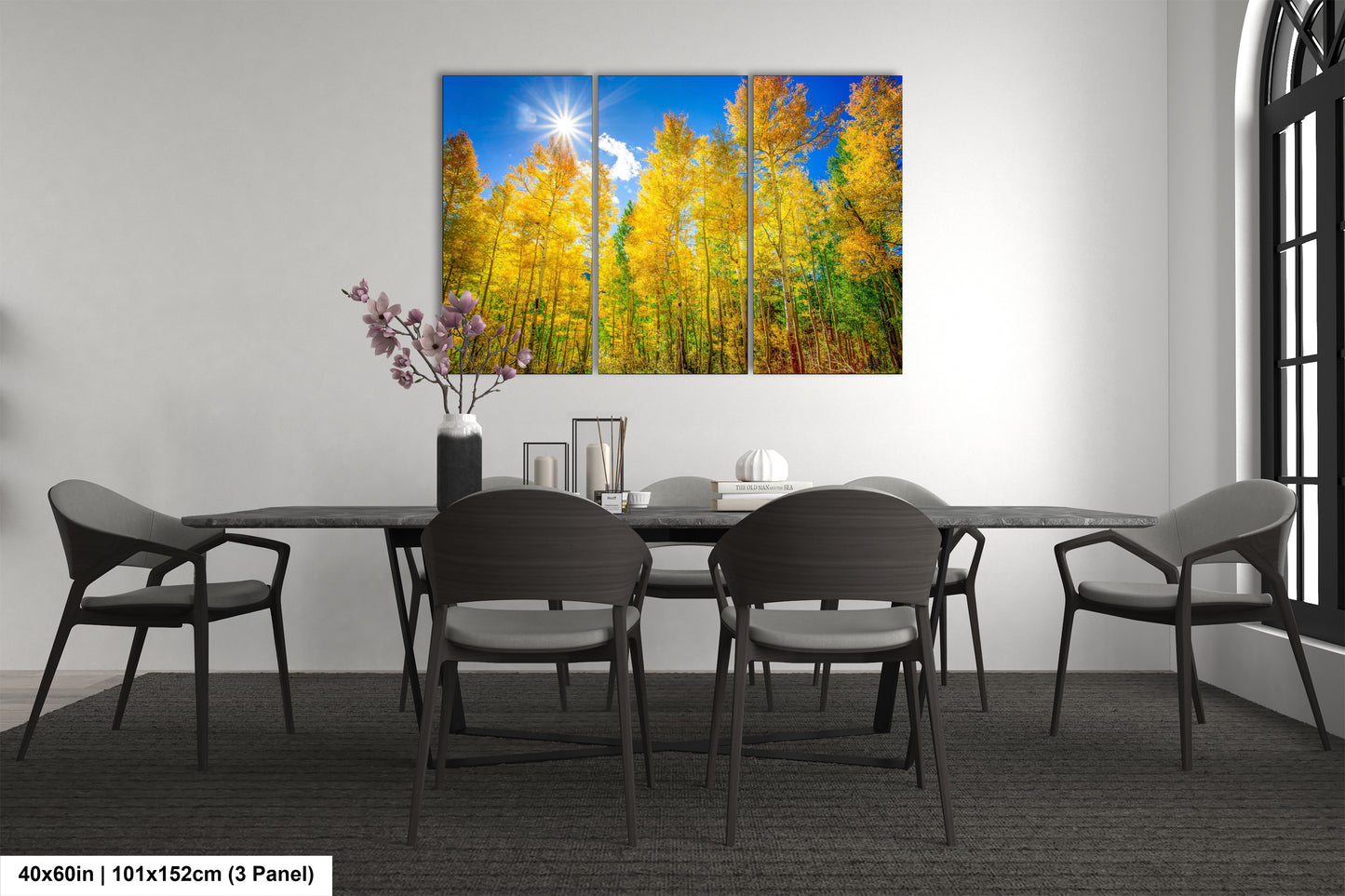a dining room table with four chairs and a painting on the wall