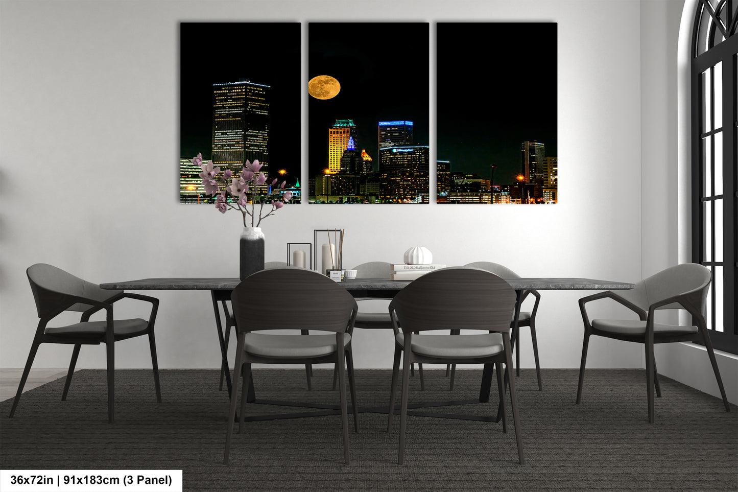a dining room table with four chairs and a vase of flowers
