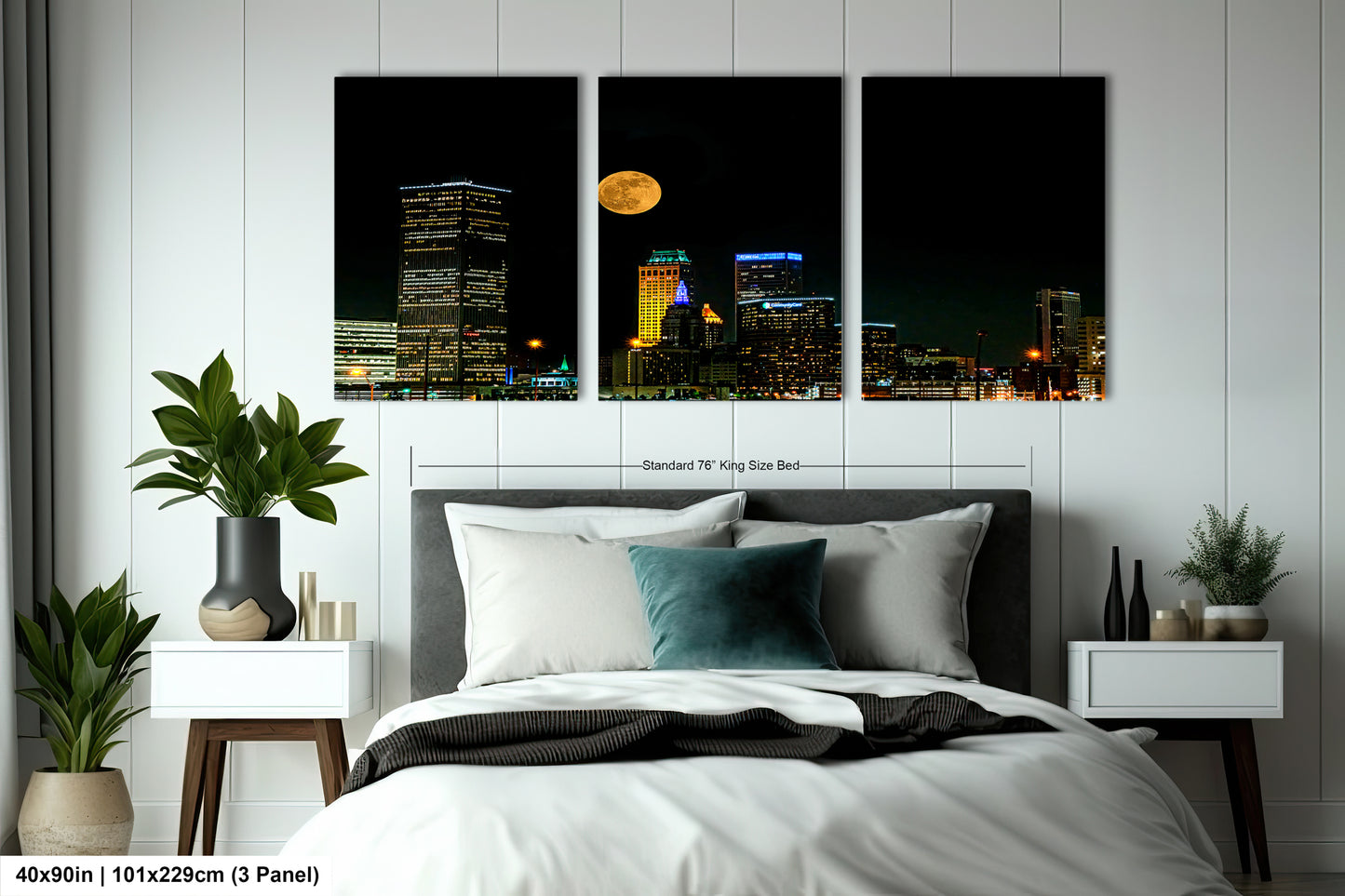 a bed in a room with three pictures on the wall