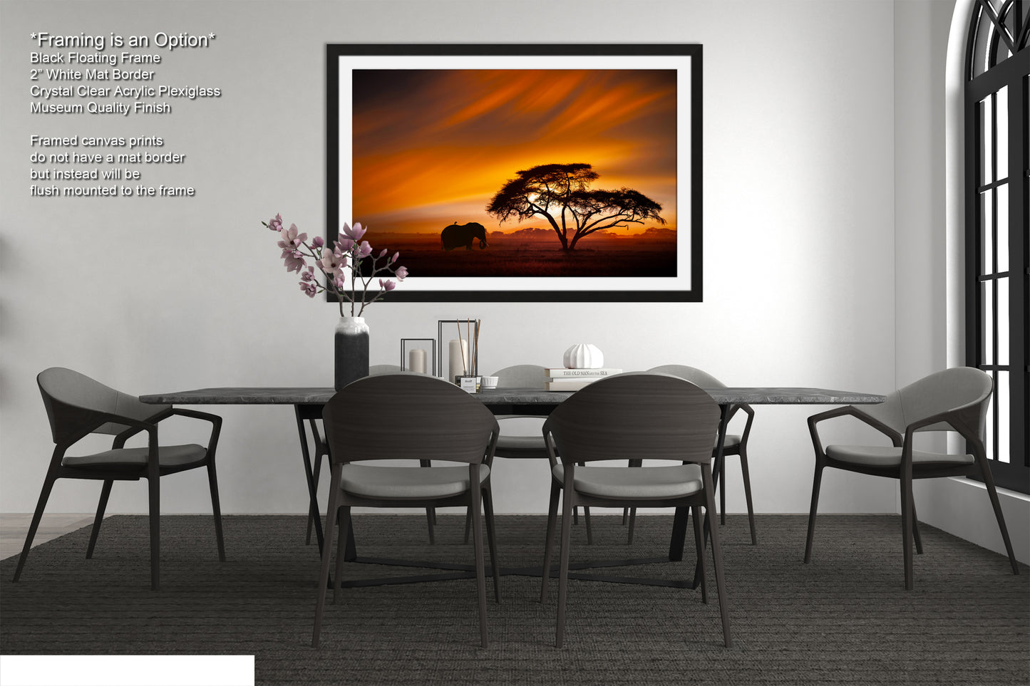 a dining room with a table and chairs and a picture hanging on the wall