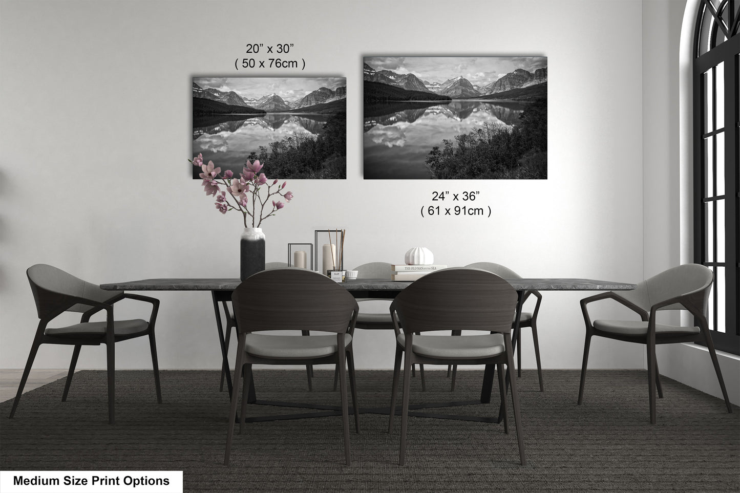 a dining table with four chairs and a vase of flowers