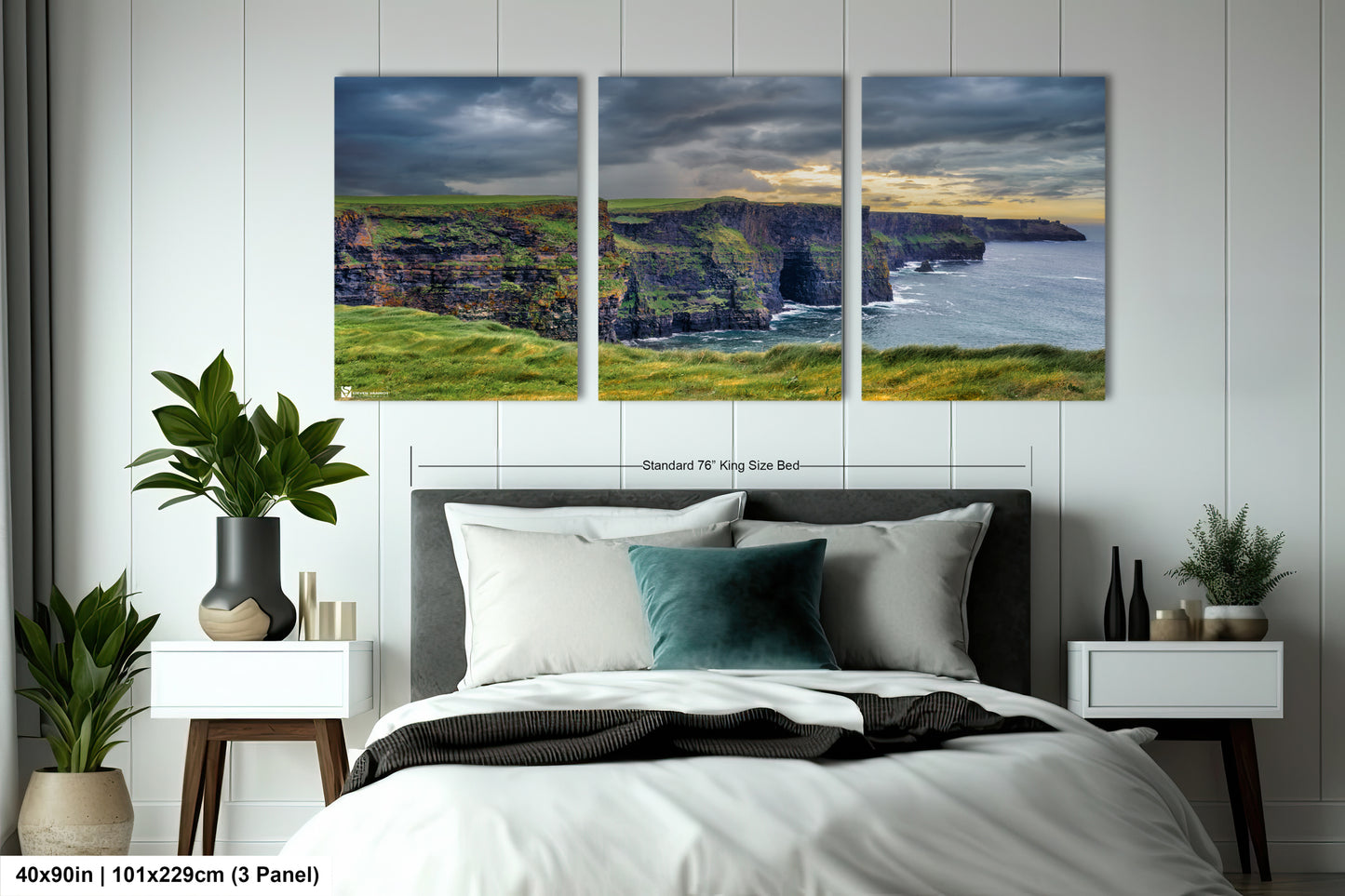 a bedroom with a bed and two paintings on the wall