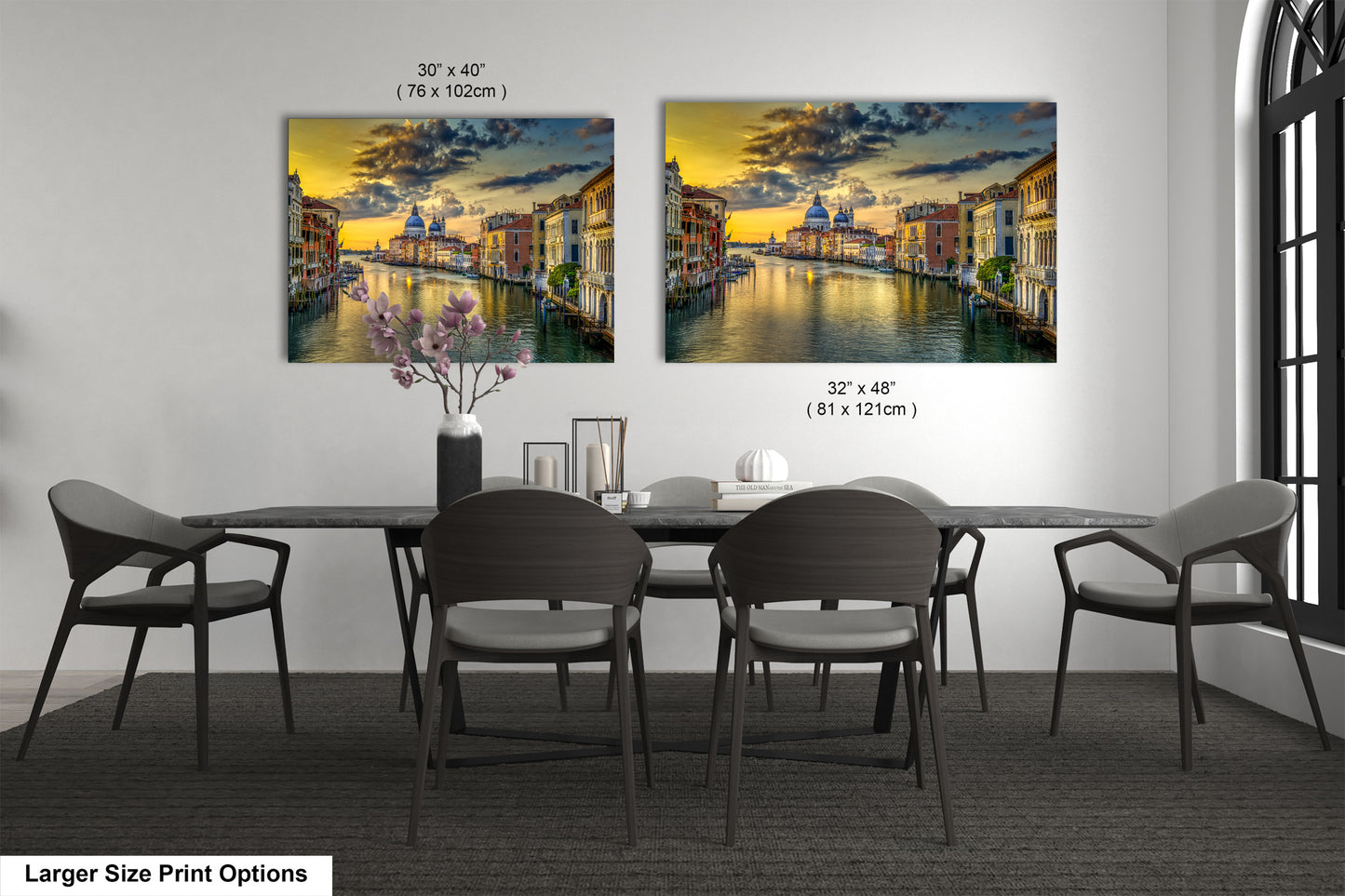 a dining room table with chairs and a painting on the wall