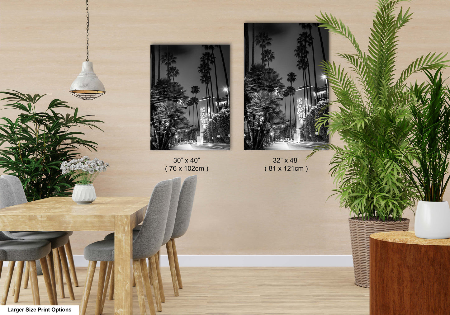 a dining room with a table and chairs next to a potted plant