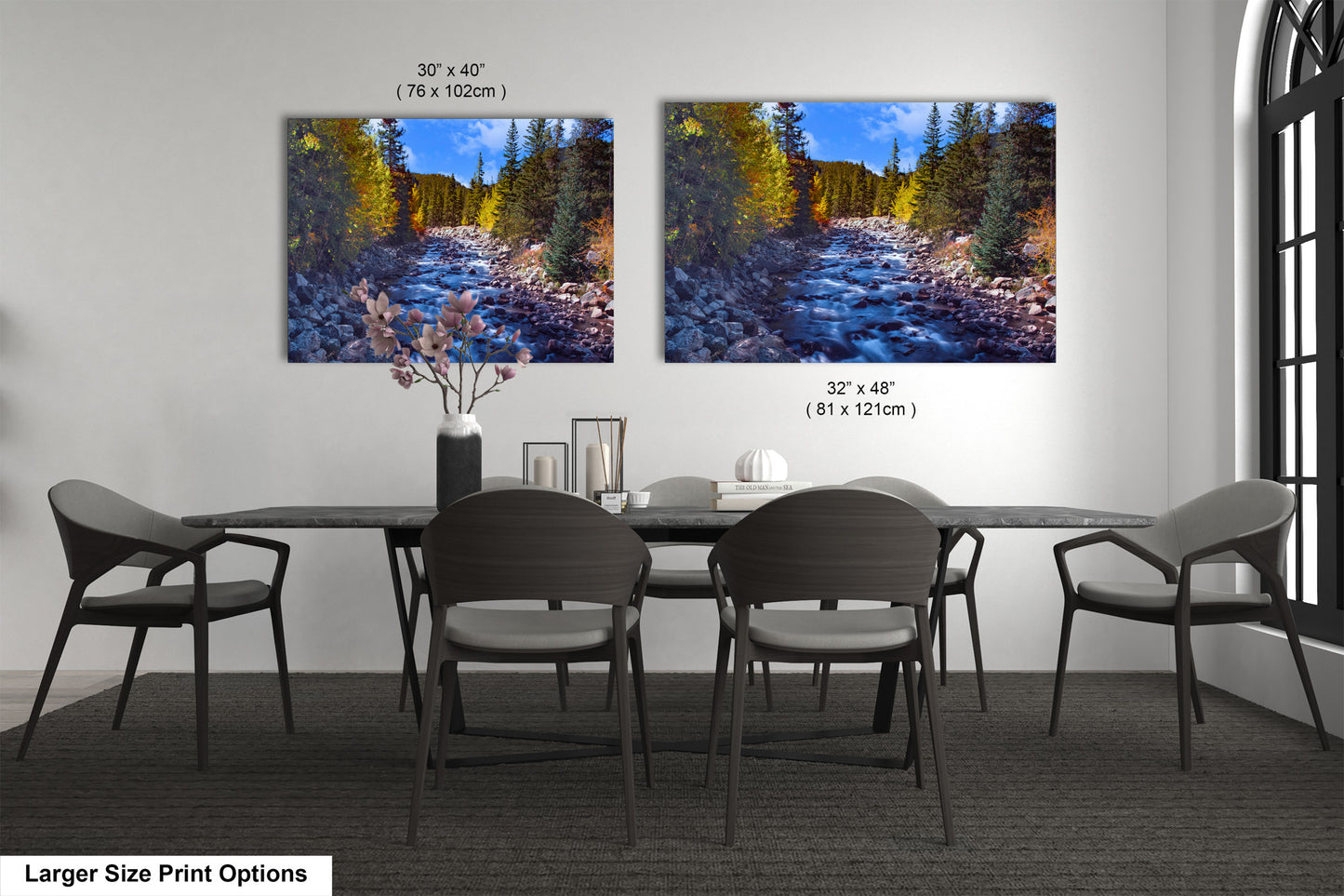 a dining room table with four chairs and two pictures on the wall