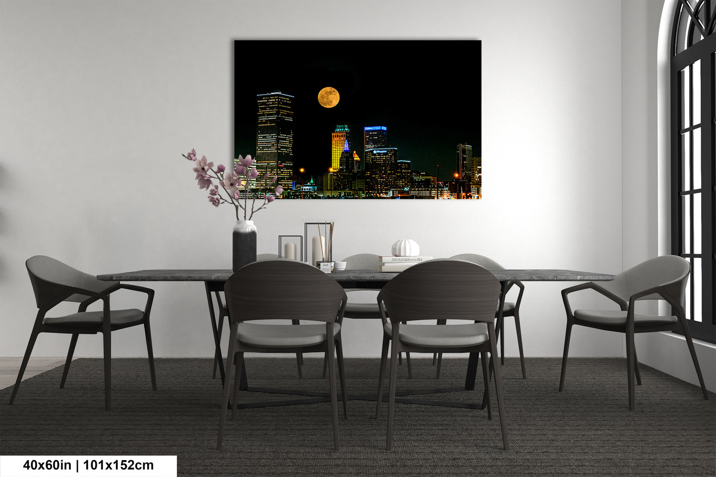 a dining room table with chairs and a vase of flowers
