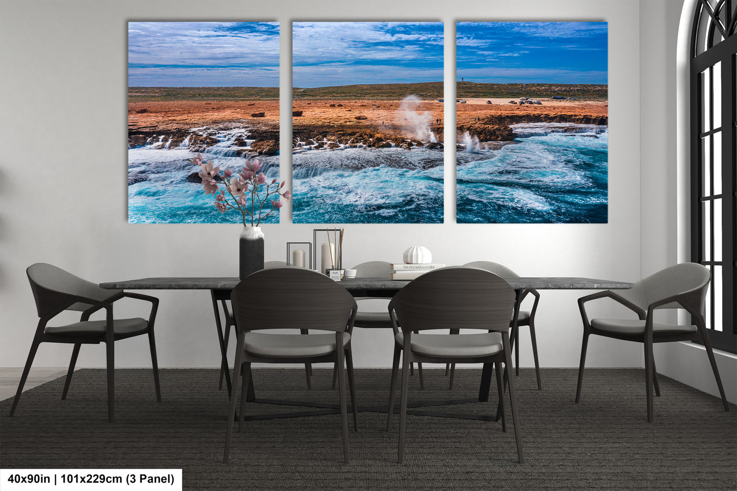 a dining room table with chairs and a painting on the wall