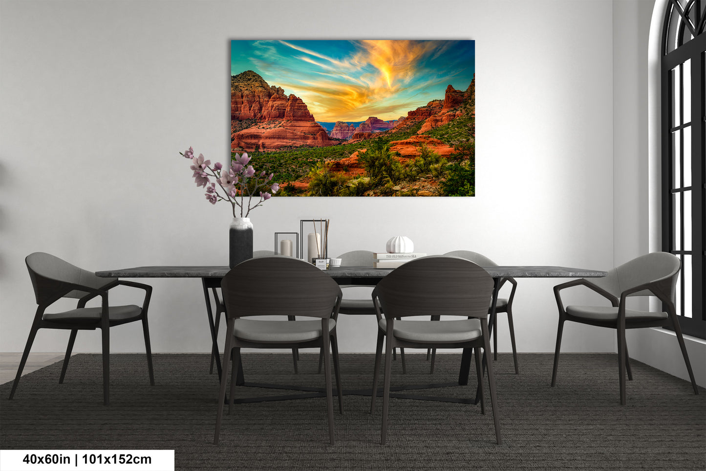 a dining room table with chairs and a painting on the wall