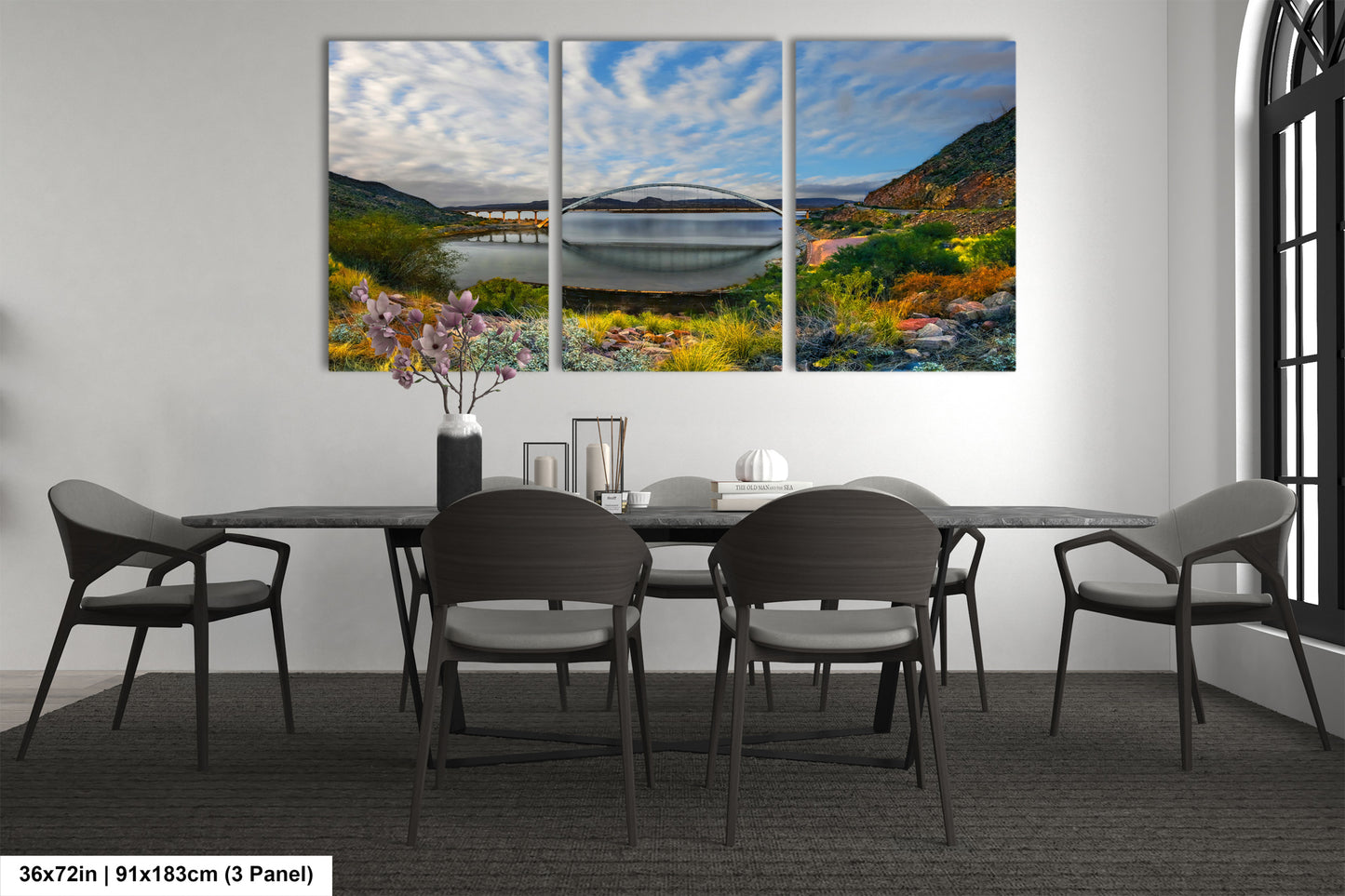 a dining room table with four chairs and a painting on the wall