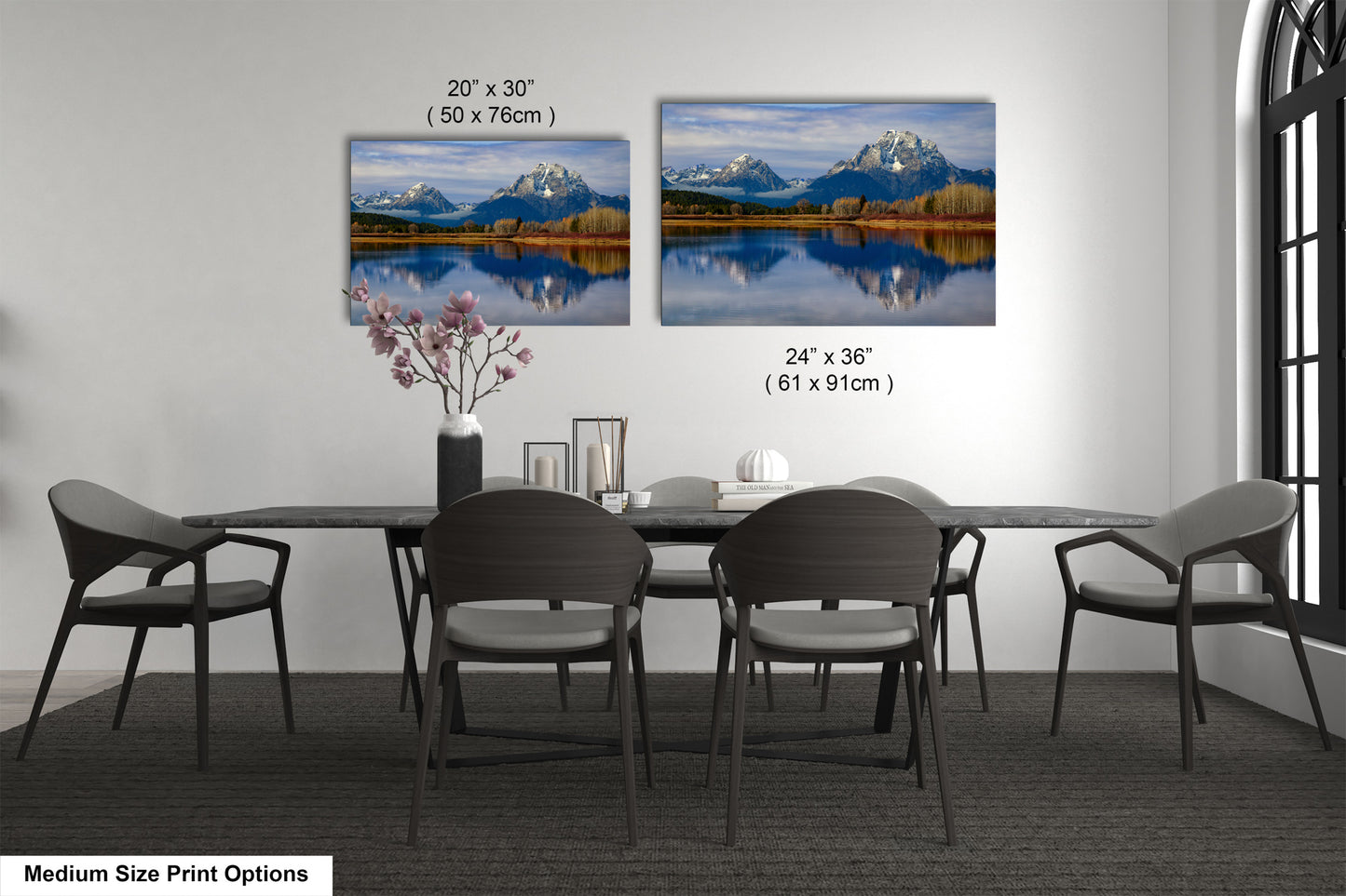a dining table with four chairs and a vase of flowers