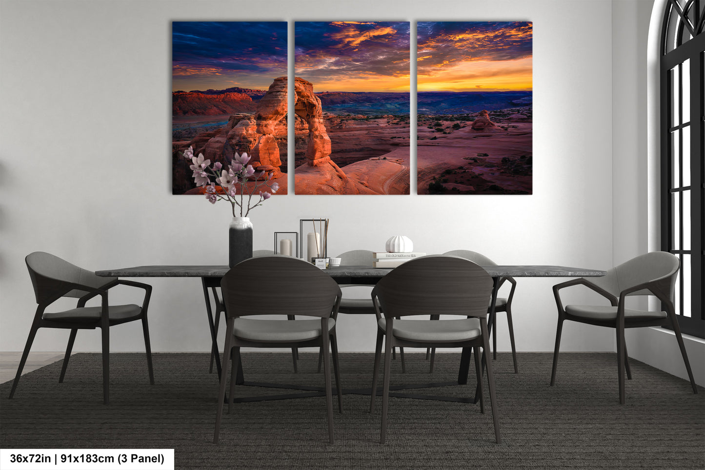 a dining room table with chairs and a painting on the wall