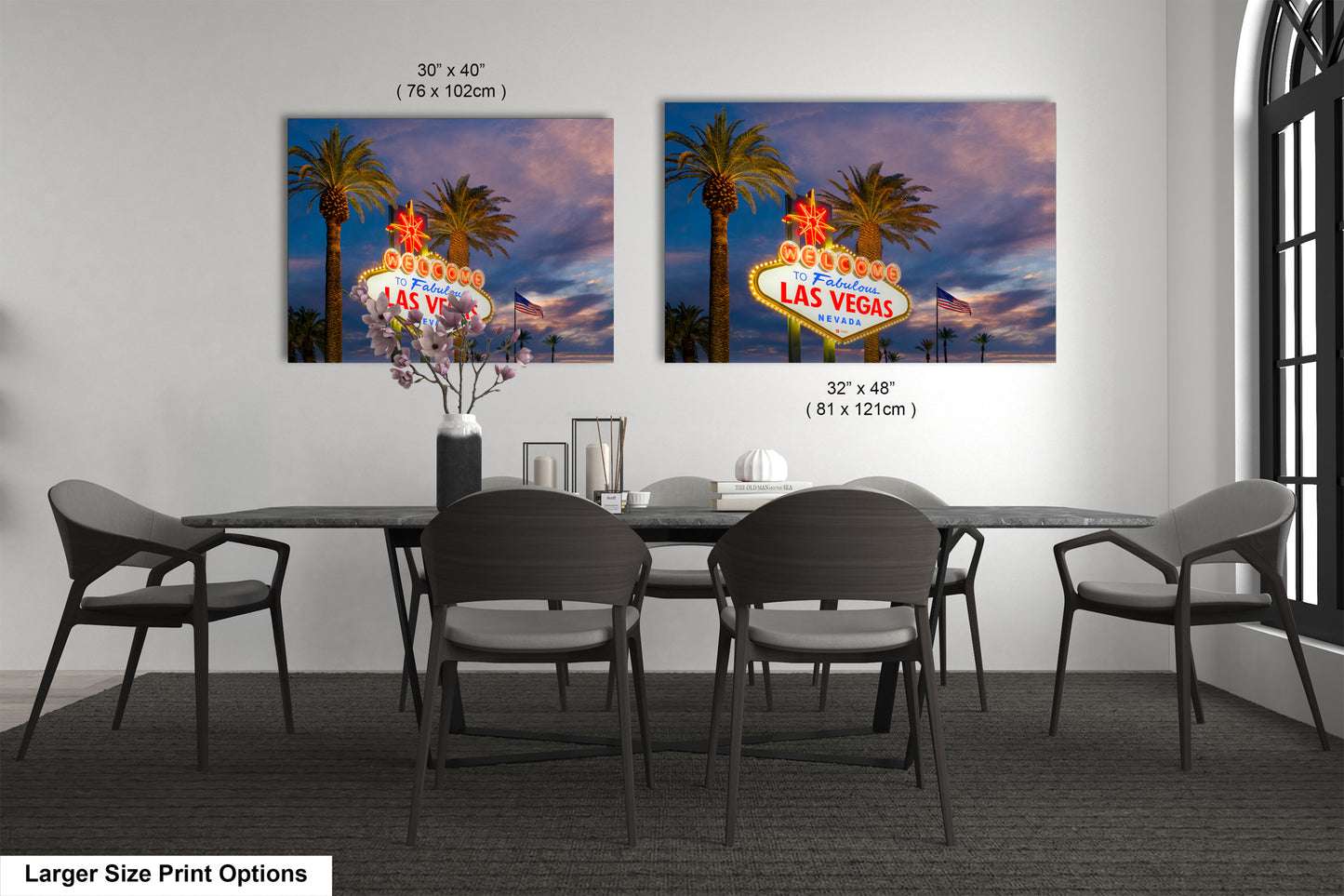 a dining room table with four chairs and a large picture of the las vegas sign