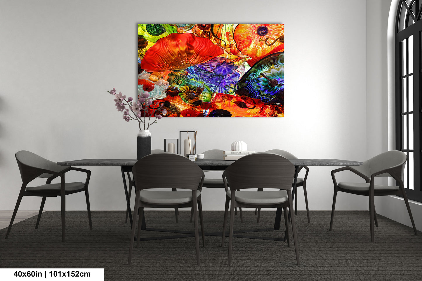 a dining room table with chairs and a painting on the wall