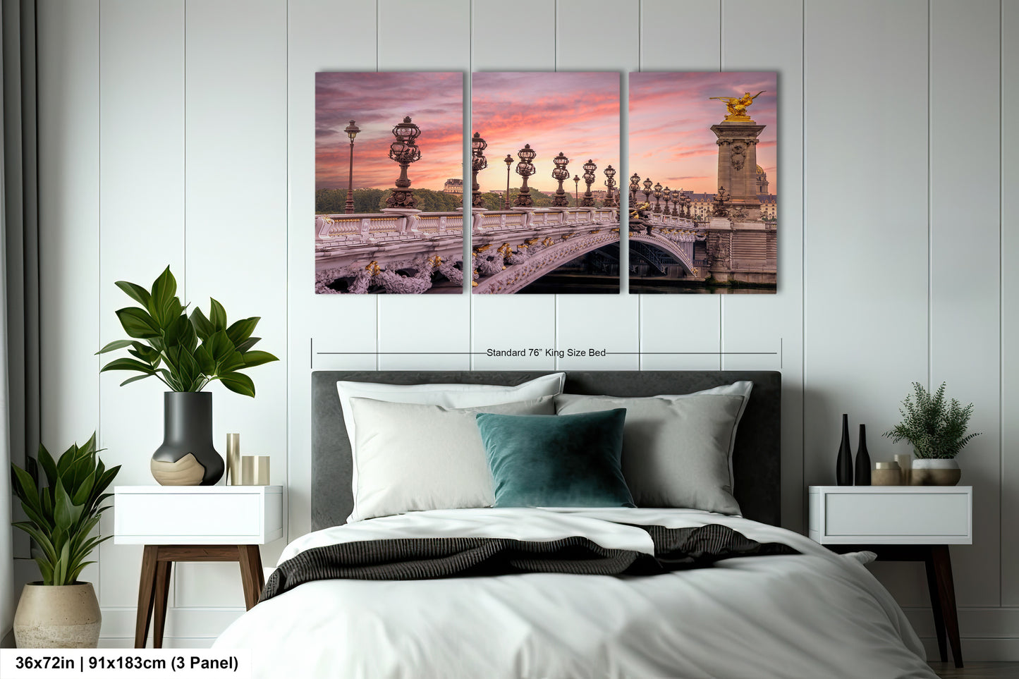 a bed with a white comforter and two paintings on the wall