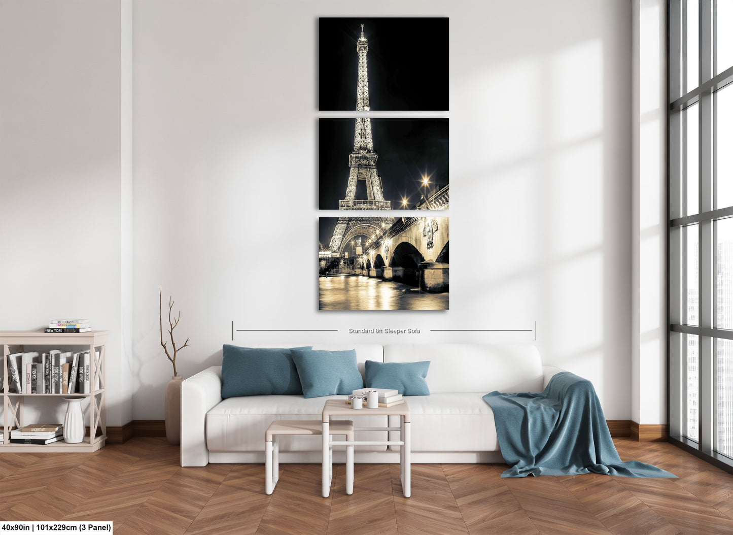 a living room with a white couch and three pictures of the eiffel tower