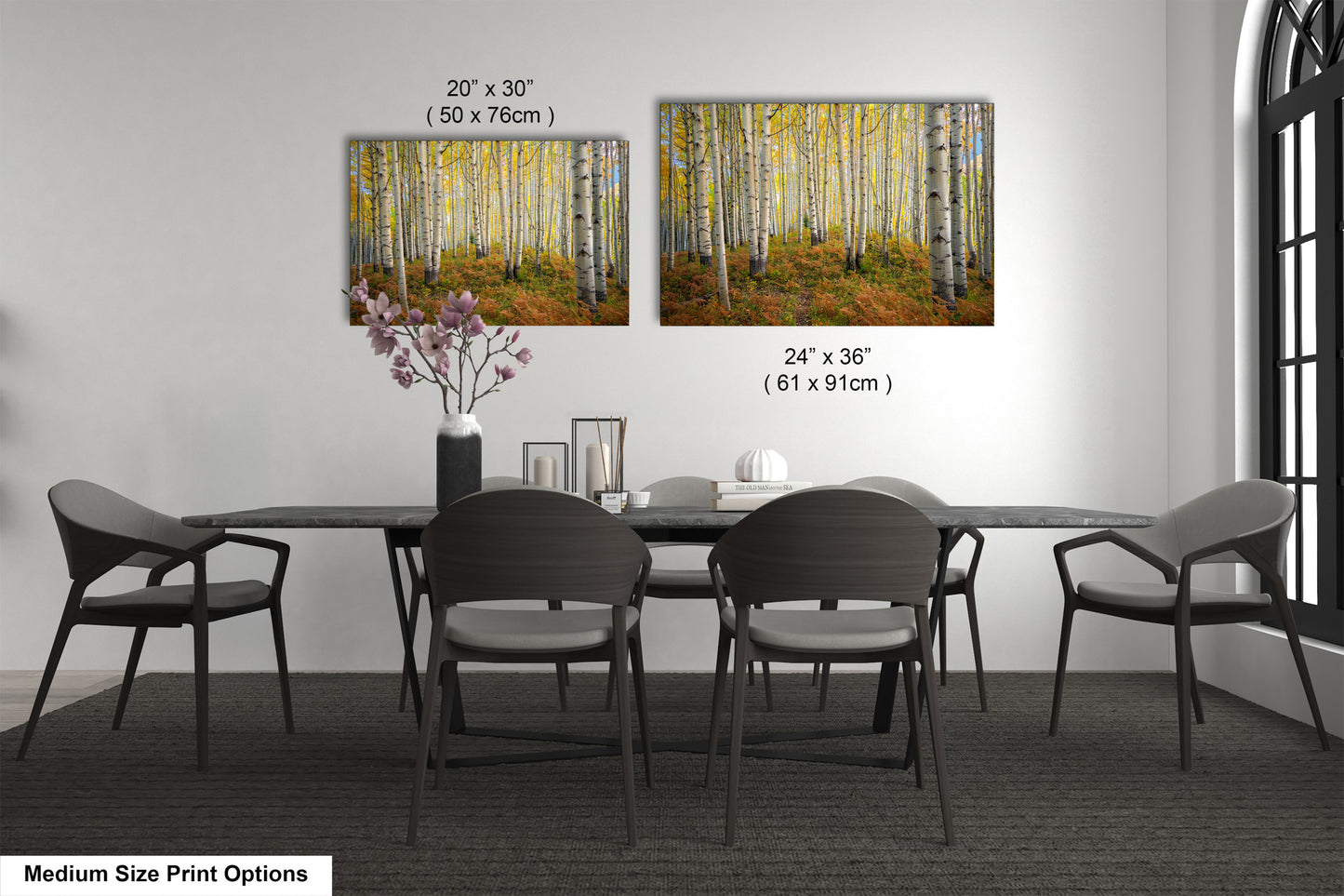 a dining table with four chairs and a vase of flowers