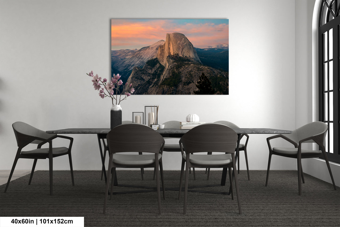 a dining room table with chairs and a painting on the wall