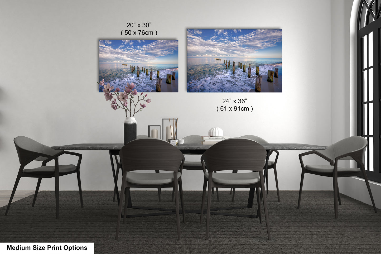 a dining room table with four chairs and a vase with flowers