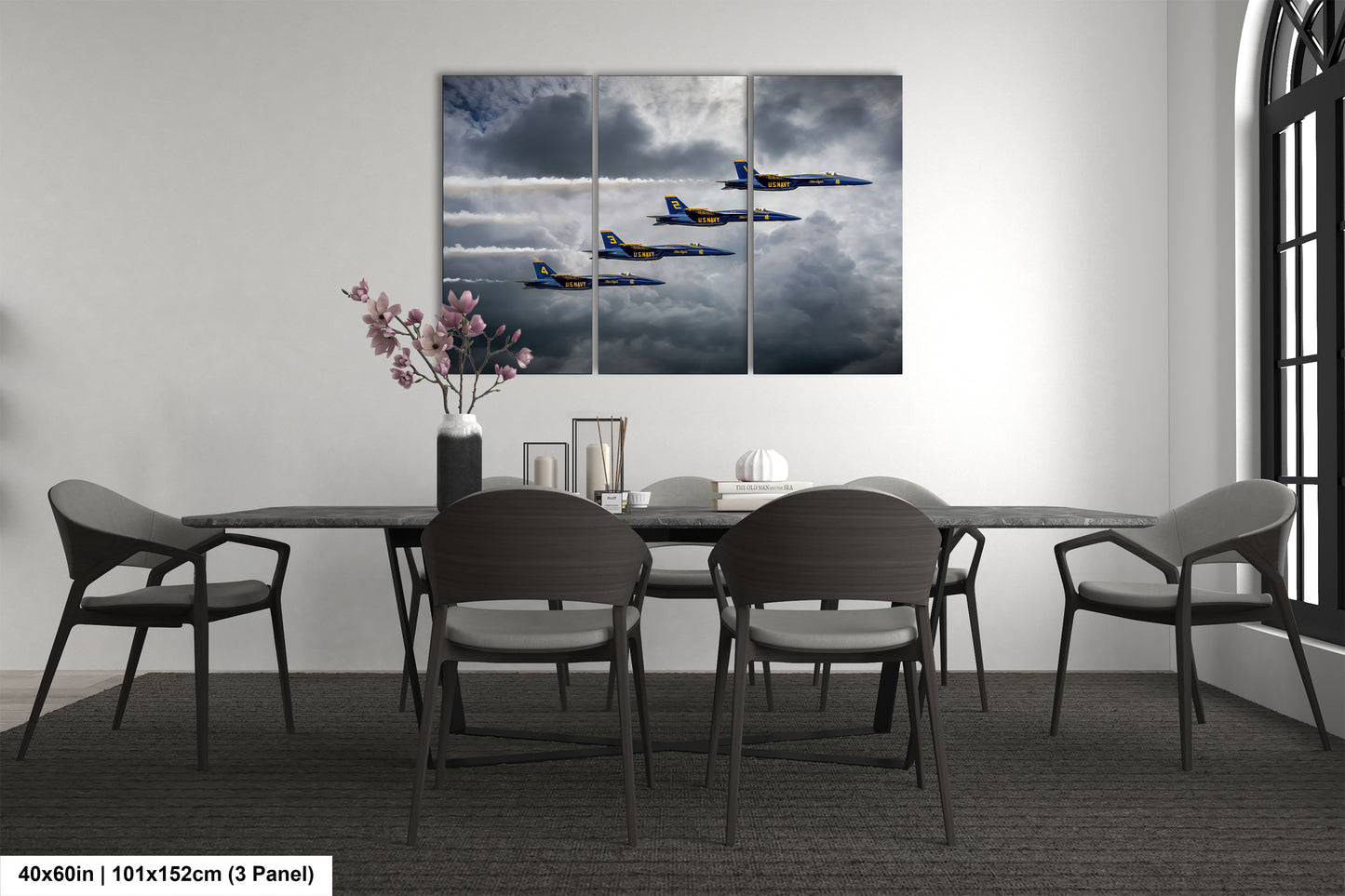 a dining room table with four chairs and a painting on the wall
