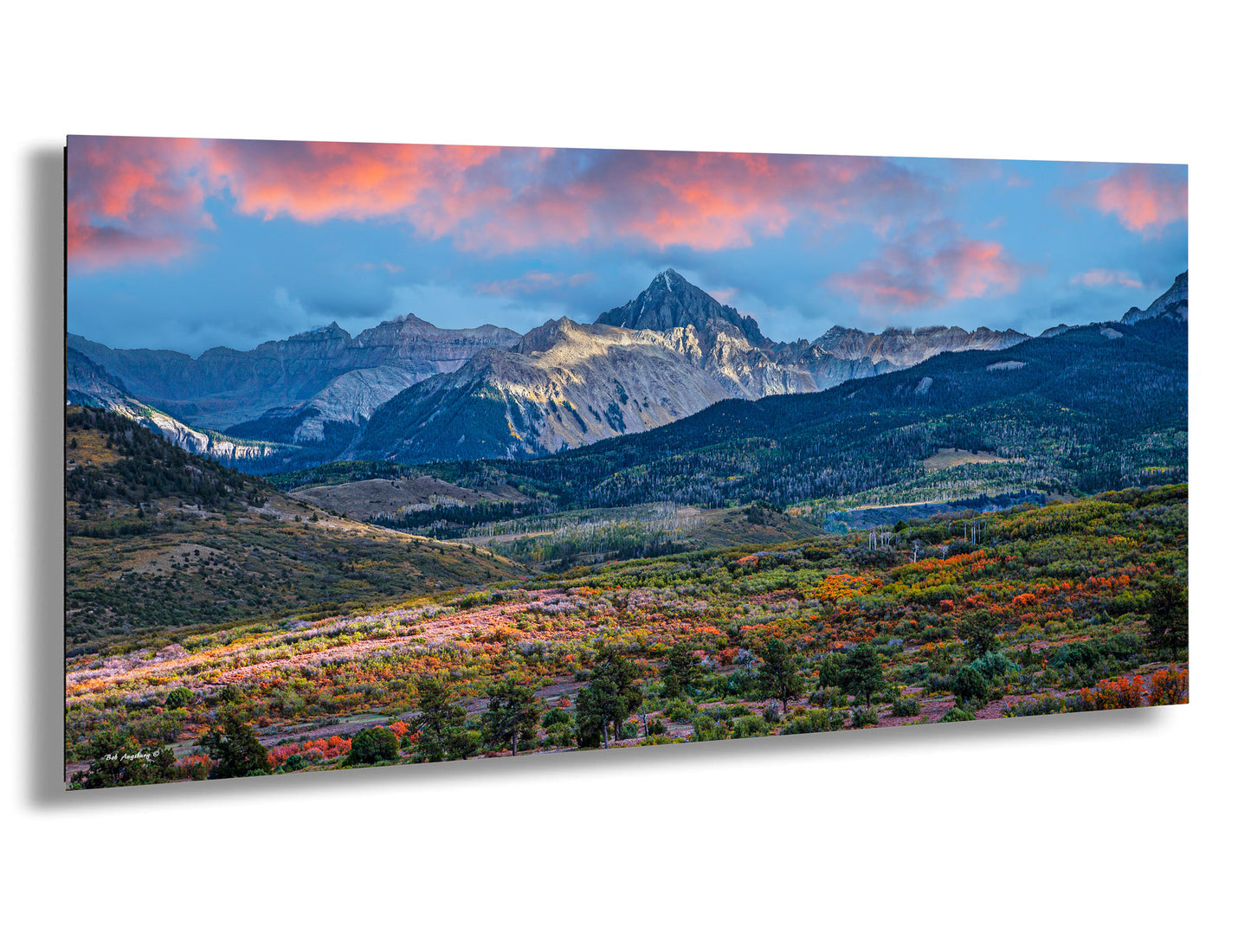 a scenic view of a mountain range at sunset