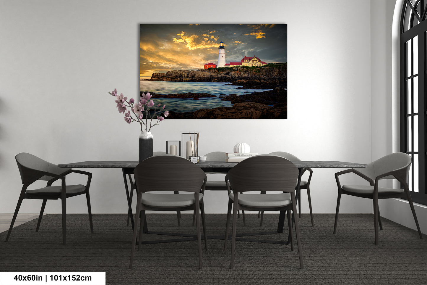 a dining room table with chairs and a painting on the wall