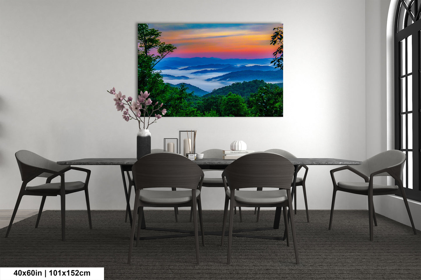 a dining room table with chairs and a painting on the wall