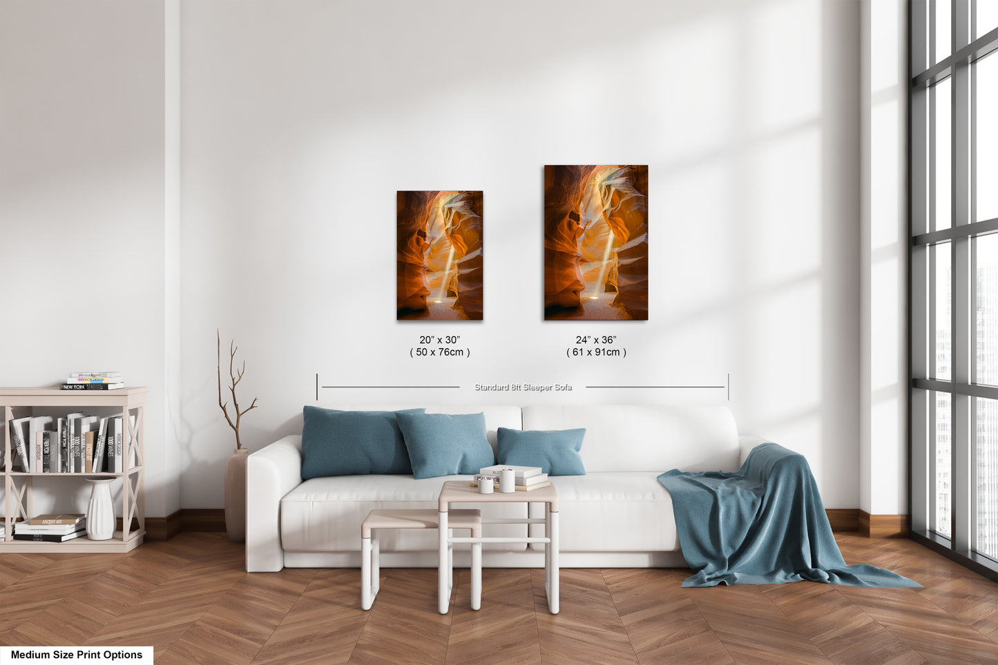 a living room with a white couch and two paintings on the wall