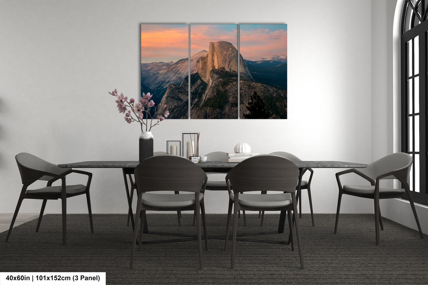 a dining room table with four chairs and a mountain in the background