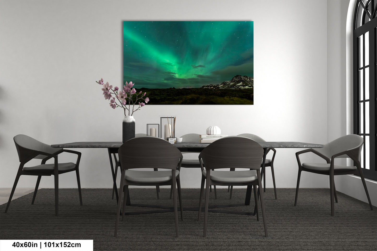 a room with a table and chairs and a painting on the wall
