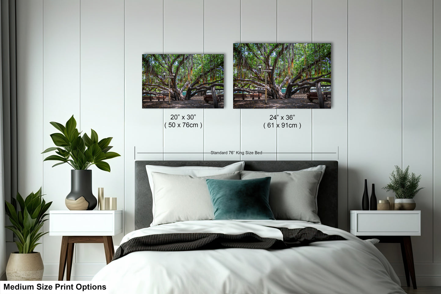 a bed with a white comforter and two pictures on the wall above it