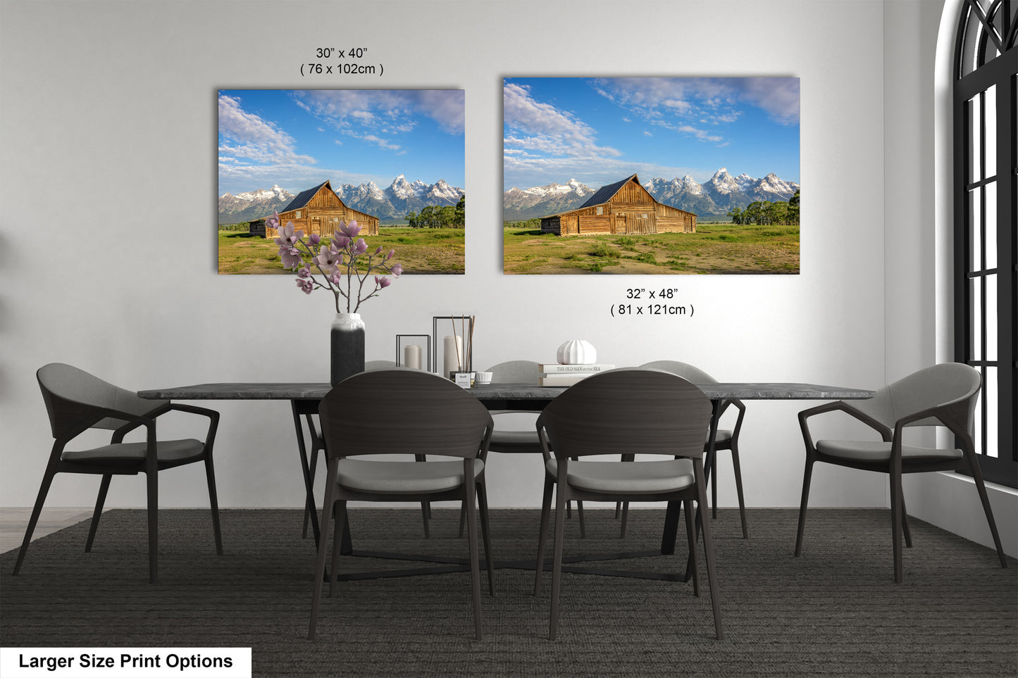a dining room table with four chairs and a vase of flowers