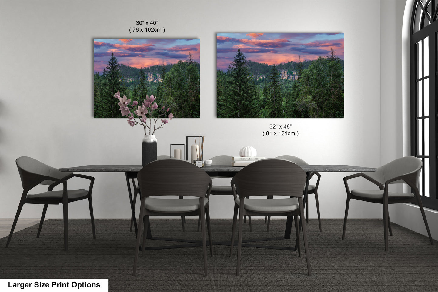 a dining room table with four chairs and a vase of flowers