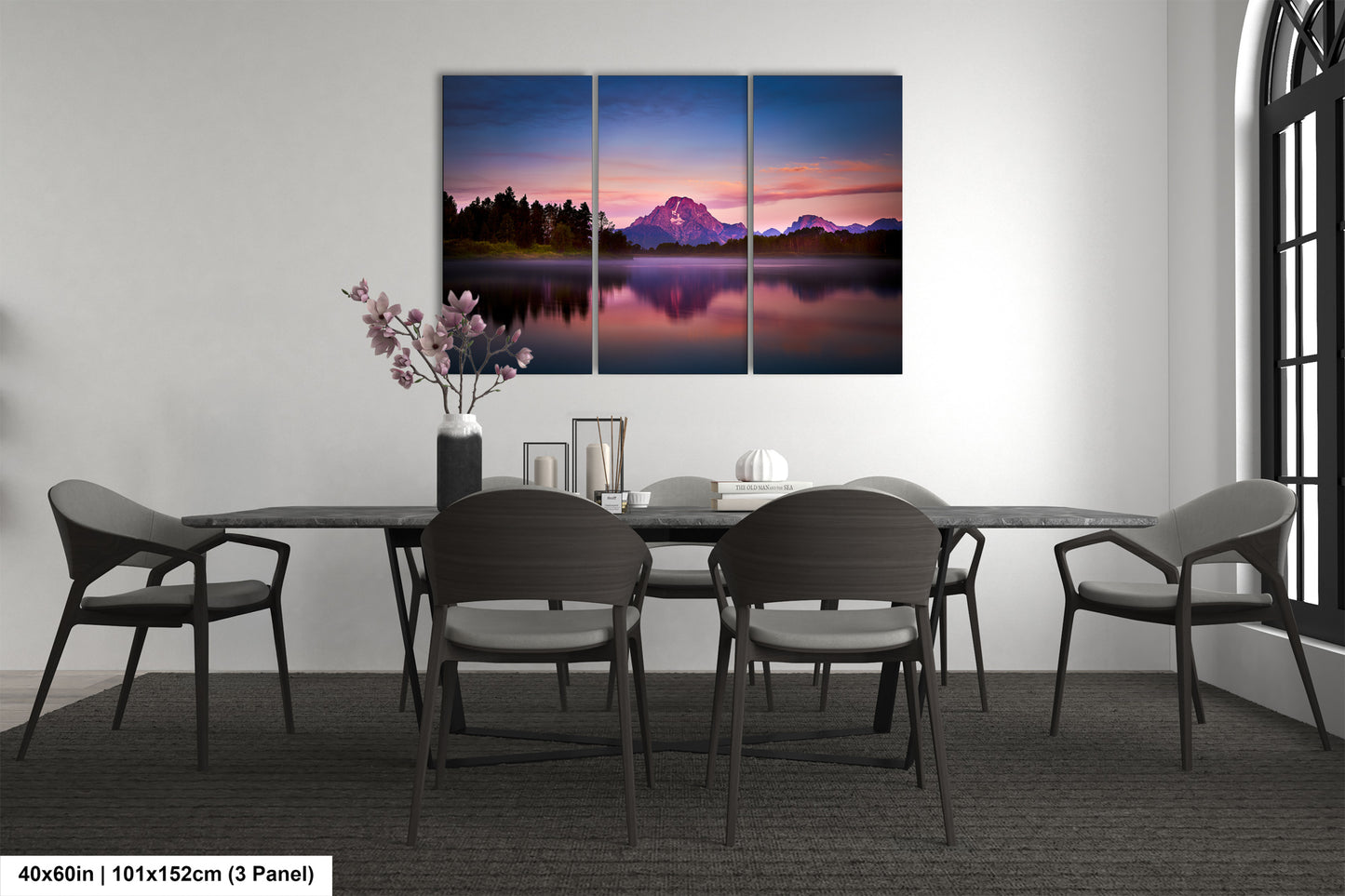 a dining room table with chairs and a painting on the wall
