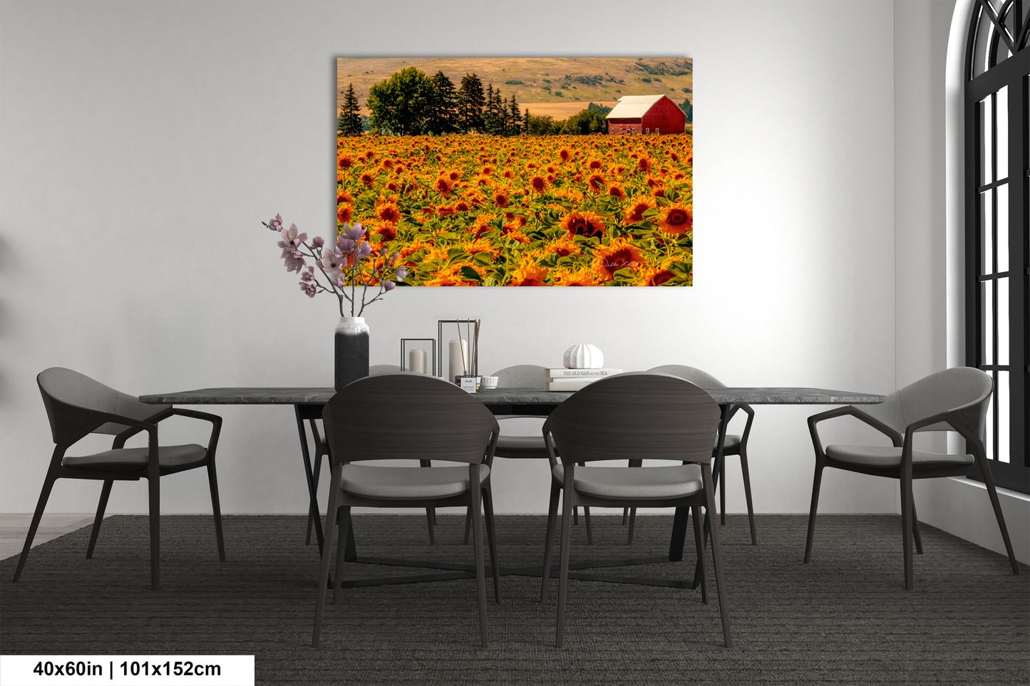 a room with a table and chairs and a painting on the wall