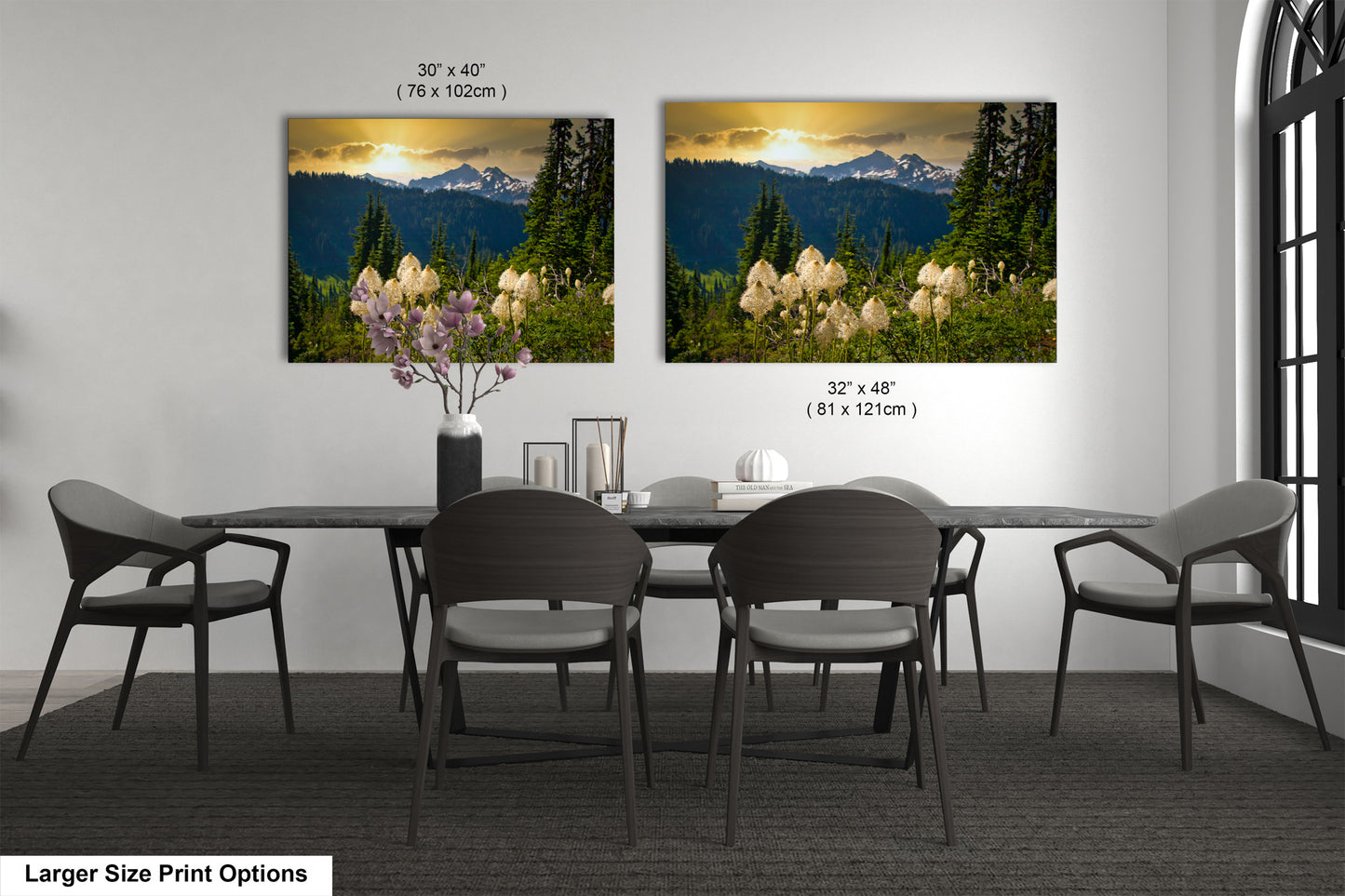 a dining room table with four chairs and a vase of flowers