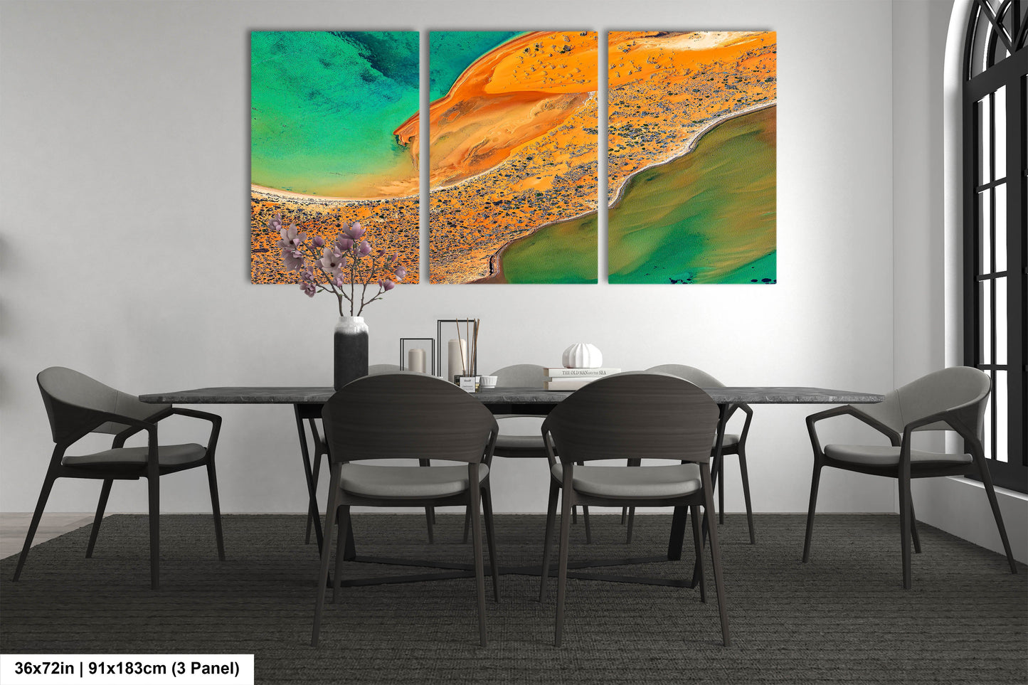 a dining room table with chairs and a painting on the wall