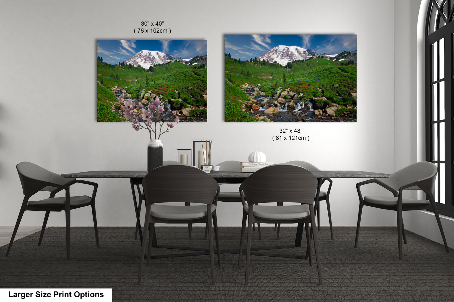 a dining room table with four chairs and two pictures on the wall