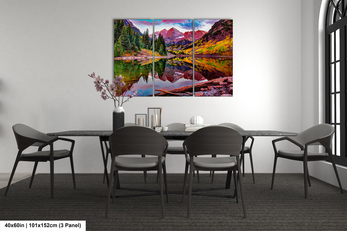 a dining room table with chairs and a painting on the wall