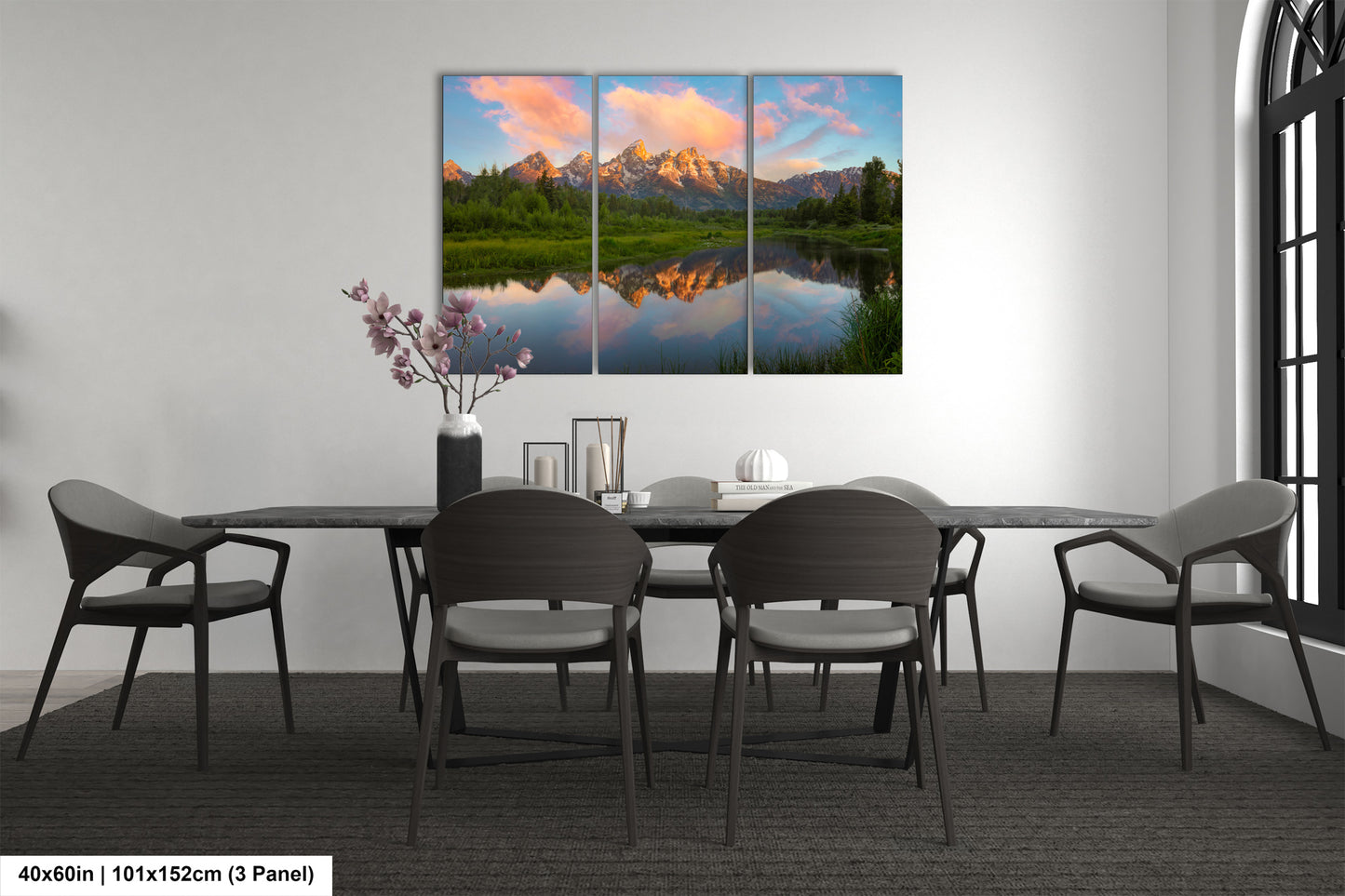 a dining room table with four chairs and a painting on the wall