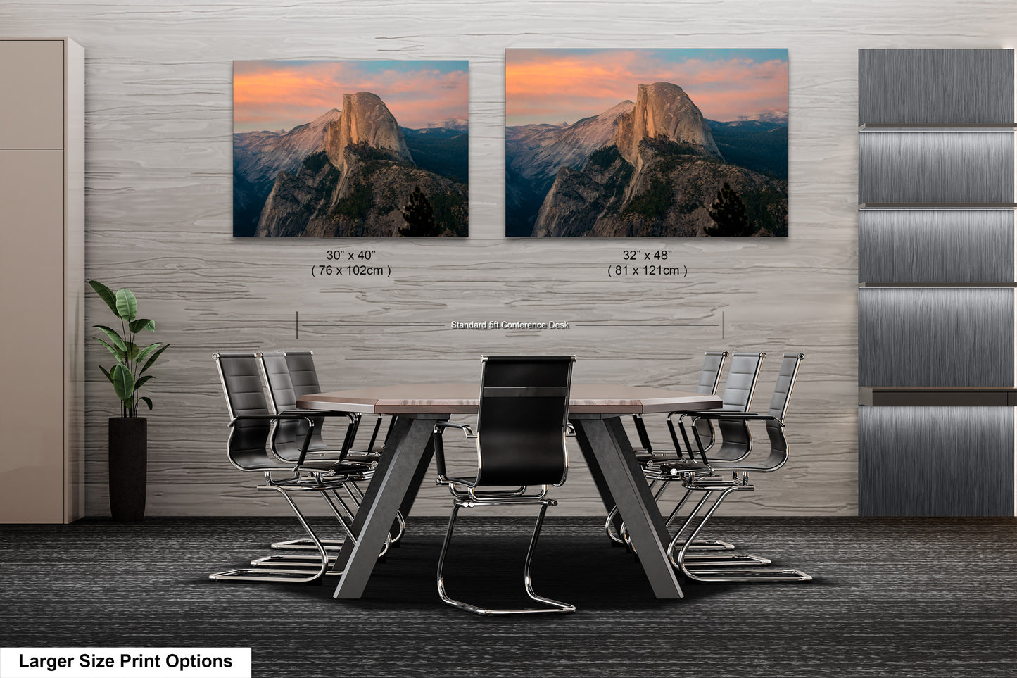 a dining room table with chairs in front of two pictures of mountains
