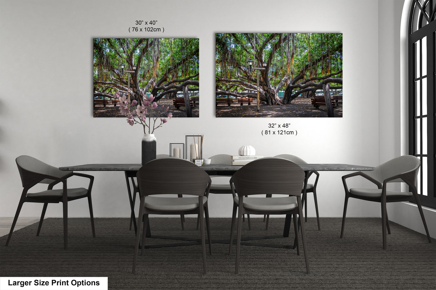 a dining table with four chairs and a vase of flowers