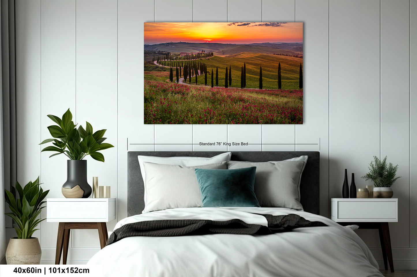 a bed room with a neatly made bed and a painting on the wall