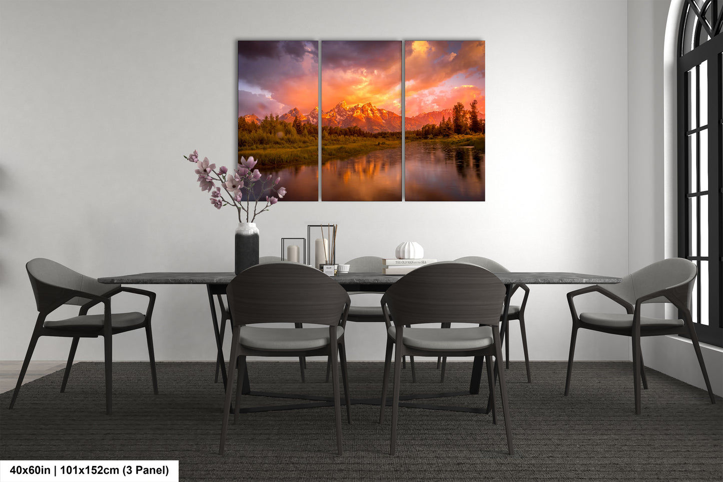 a dining room table with chairs and a painting on the wall