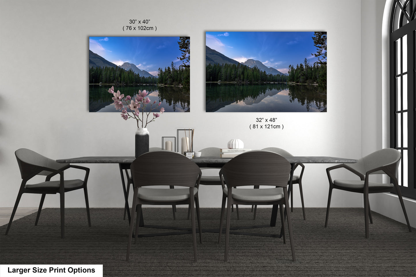 a dining table with four chairs and a vase of flowers