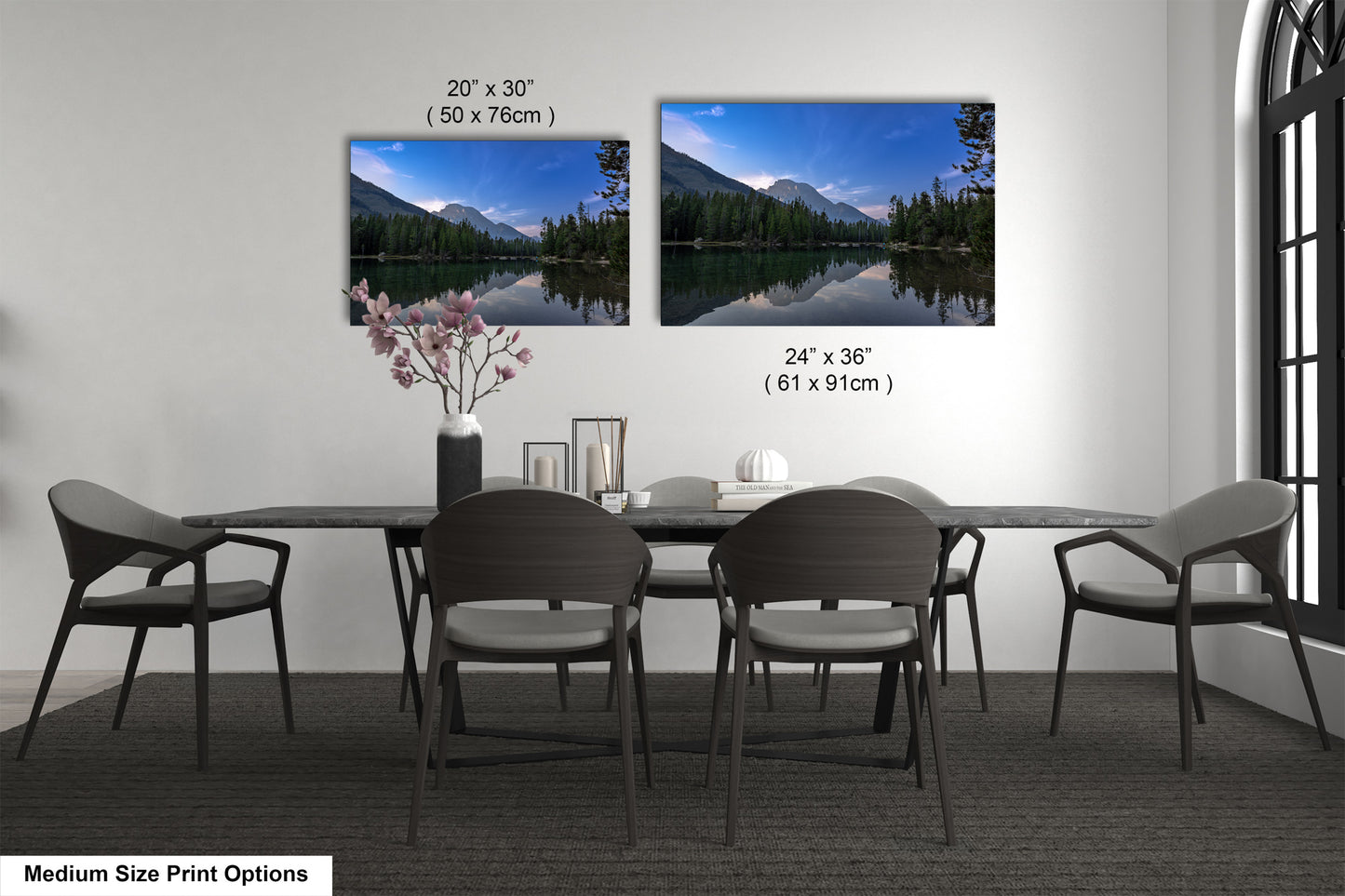a dining table with four chairs and a vase of flowers
