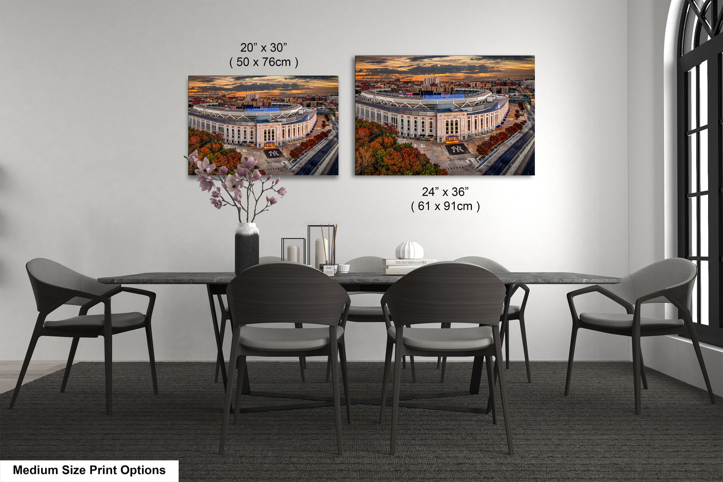 a dining room table with four chairs and a vase of flowers